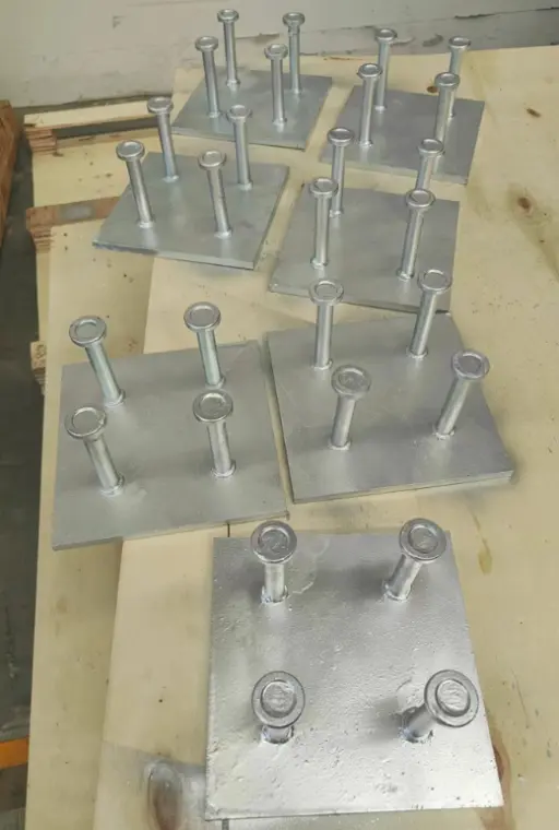 Industrial steel embed plates with headed studs for reinforced concrete structural anchoring and support.