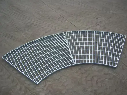 Custom fan-shaped radial steel grating fabricated to fit around circular tanks, columns, and curved structures.